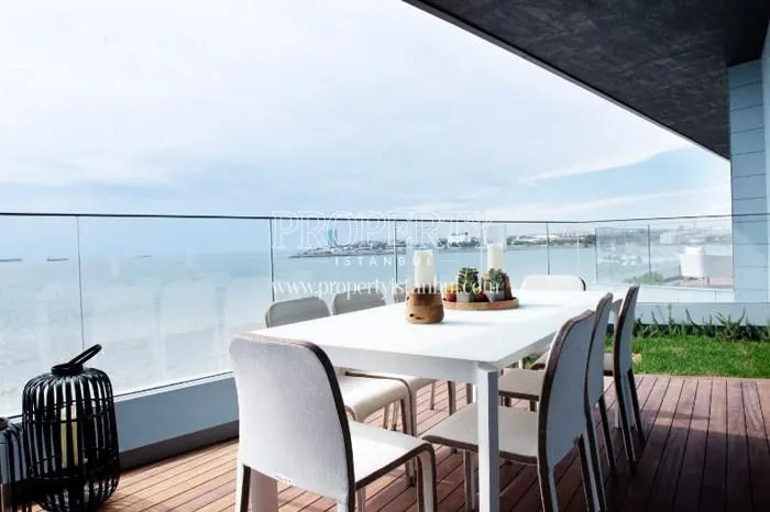 White dining table on the balcony in front of the sea in Sea Pearl Atakoy
