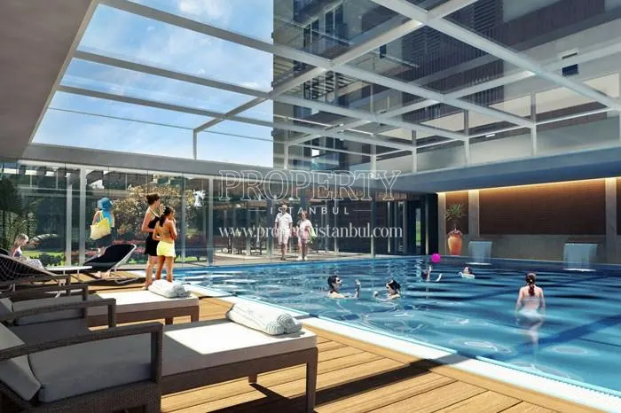 The residents swimming in the glass-ceilinged indoor swimming pool of 216 Butik Plus Rezidans