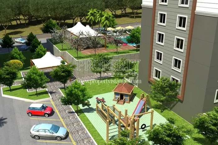Playground for children and parking lot in The view of the swimming pool in Apricot Garden Evleri