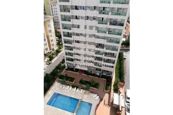 Outdoor swimming pool in front of Aram Deluxe building