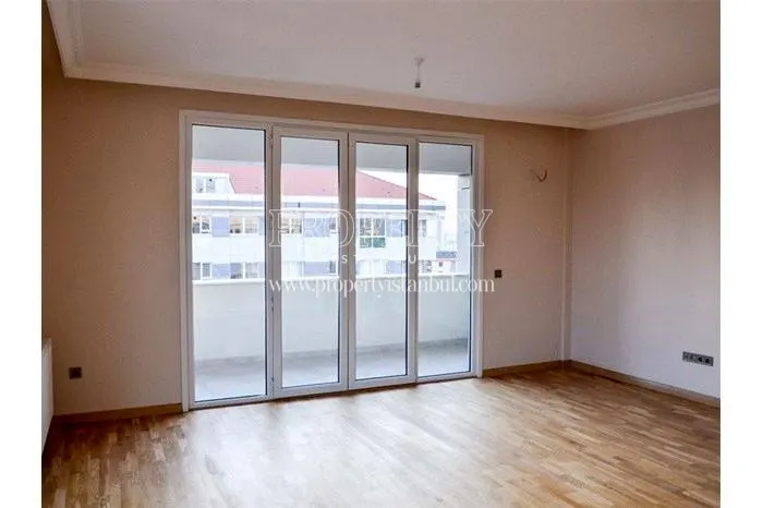 Empty room with balcony in one of the Aram Deluxe apartments