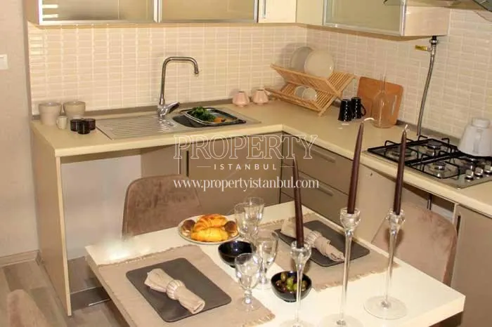 Small kitchen with a set table in Aris Park Residence