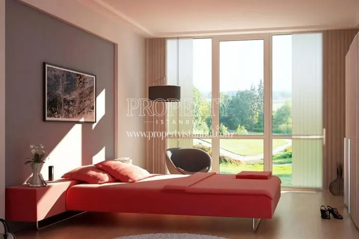 Small bedroom with a red single bed in Basak Vadi Konutlari