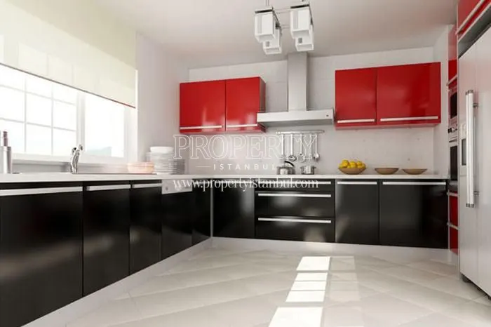 The kitchen with black kitchen cabinets in City Court Bahcesehir