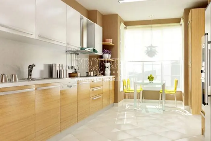 The kitchen with wooden kitchen cabinets in City Court Bahcesehir