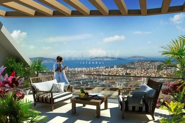 The couple looking at the sea view from their terrace in Cukurova Balkon