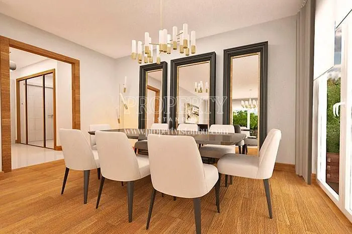 White chairs around the dining table in one of the apartments in Dekar Asmali Bahceler
