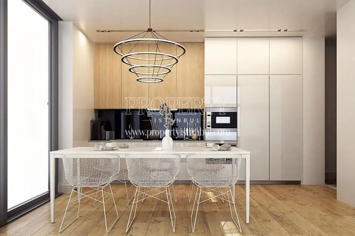 The kitchen with a glass dining table in Elexia Levent