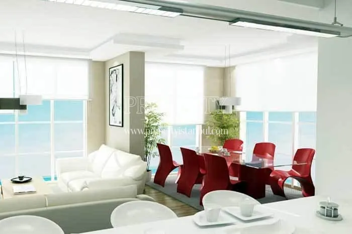 The living room with a glass dining table with red chairs in Evinpark Rezidans Atasehir