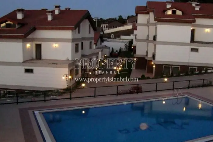 The outdoor swimming pool among the villas in Feronia Evleri