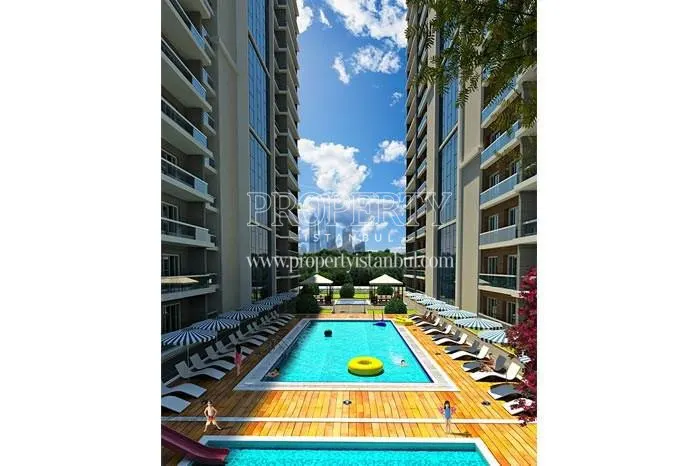 The outdoor swimming pool in Fly Salmiya Residence