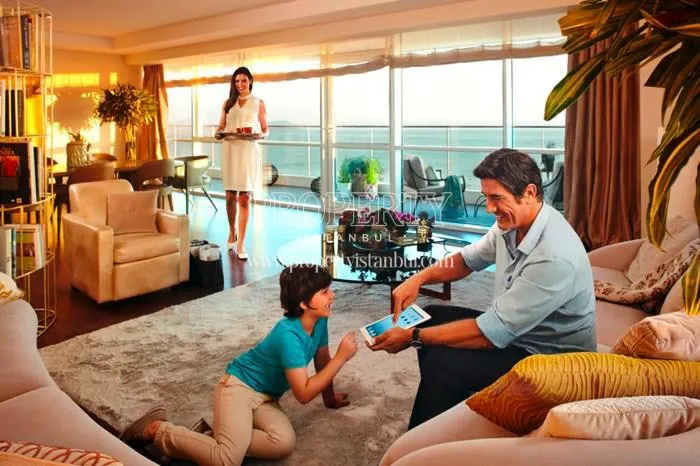 A family enjoying themselves in their living room in Four Winds Residence