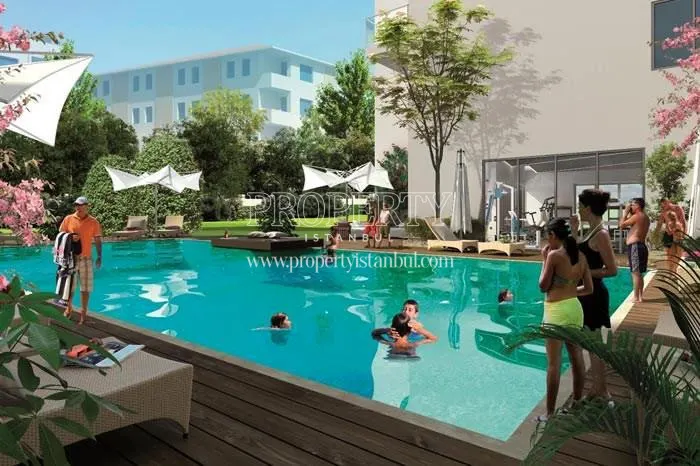 The residents of Guzel Residence are swimming in the compound pool