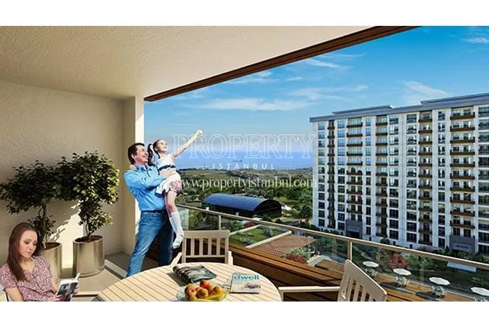 The family enjoying themselves on their balcony in Huzurlu Marmara homes