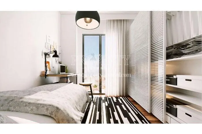 White wardrobe with black striped carpet in the small bedroom in Kayim Rezidans