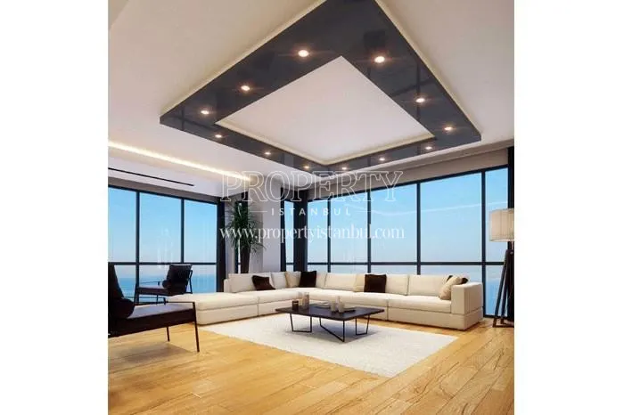 White corner sofa with balck pillows in one of the living rooms in Marin Pendik homes