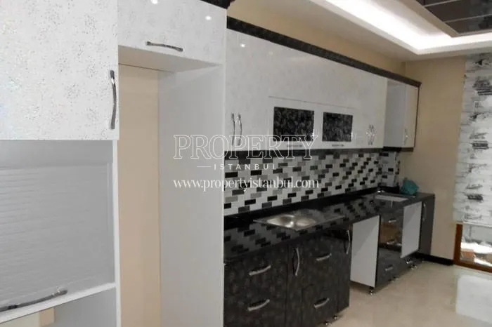 Black drawers and white kitchen cabinets in one of the kitchens of Mavera Konutlari