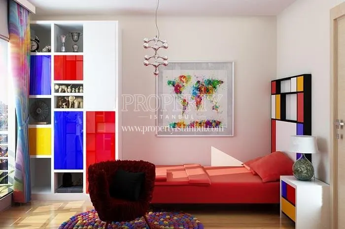 Small bedroom with a colorful cupboard and a red bed in Mihenk Rezidans