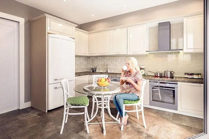 The woman drinking coffee in the kitchen in Mika Naturalist