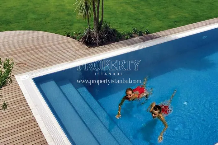 The mom and her daughter swimming in the pool in the New Loca Istanbul compound