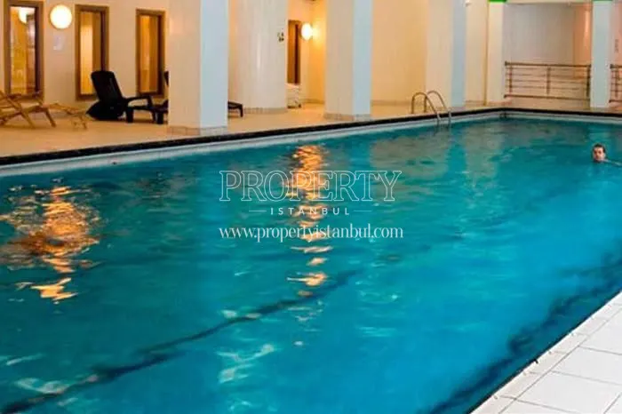 The guy swimming in the swimming pool of the Nida Life compound