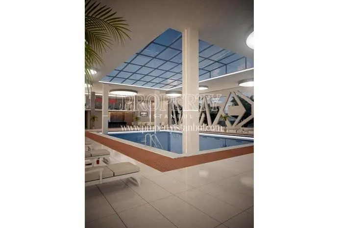 Indoor swimming pool with a glass ceiling in Nuans Residence