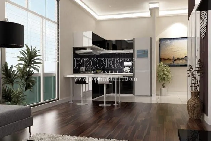 Black and white kitchen cabinets in the small kitchen in Nuans Residence
