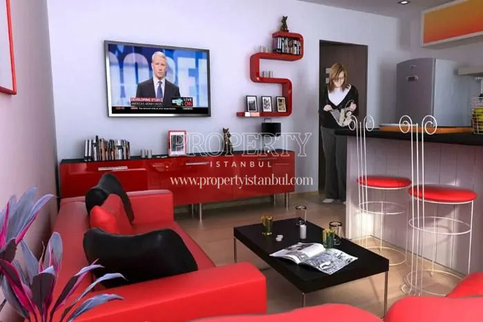 Small open kitchen with a red lounge suite in Onay Garden Residence