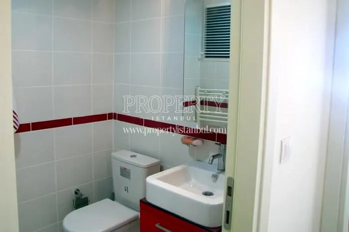 Small white and red water closet in Orion Park