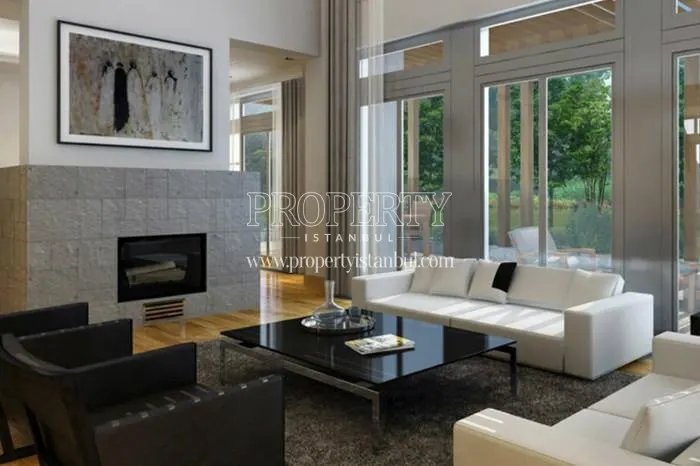Two white sofas and a black armchair in the living room with a fireplace in Ormanada