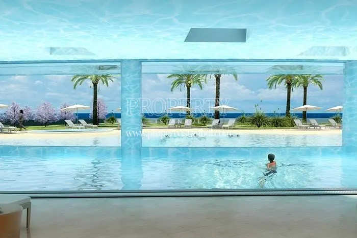The boy swimming in the Ottomare Suites compound