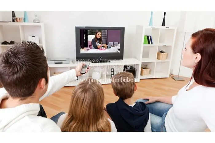 The family watching television at their home in Pirlanta Camlica