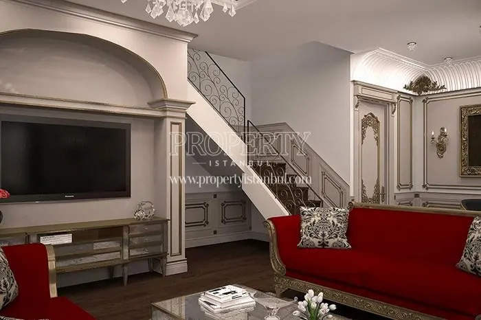 The red lounge sofa in the duplex unit's living room in Pergamon Koskleri