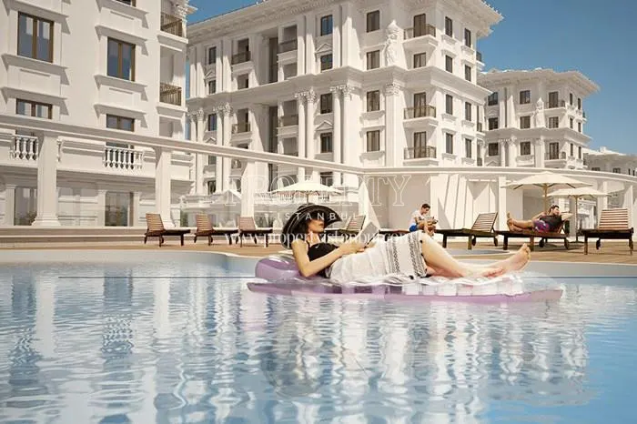 The woman lying down on an inflatable boat in the swimming pool of Pergamon Koskleri
