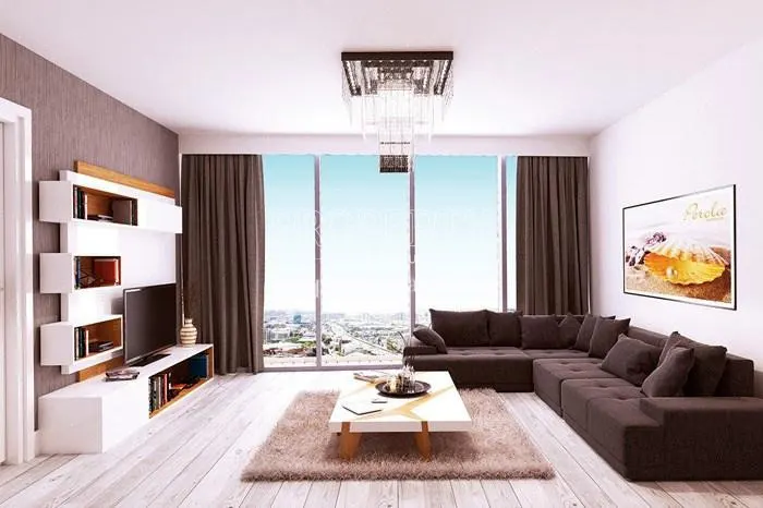Spacious living room with a black corner sofa in Perola Residence