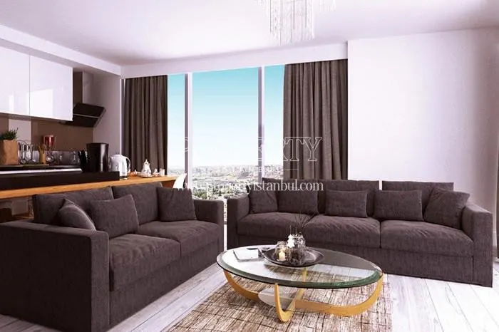 The living room with a black lounge suite in Perola Residence