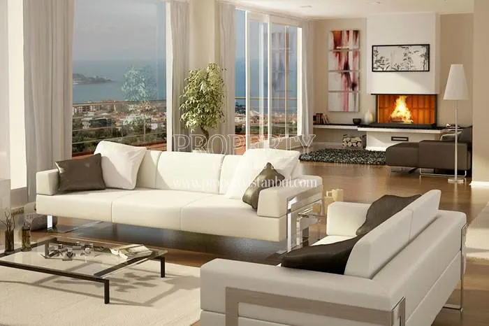The living room with a white sofa and fireplace in the Rose Garden Gurpinar project