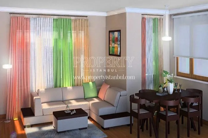 Small white corner sofa with colorful curtain in one of the Sebboy Konutlari apartments
