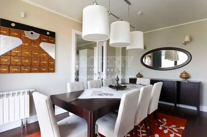 Black dining table with white chairs in Sehrizar Konaklari