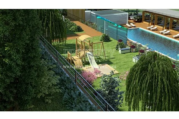 The outdoor swimming pool near the playground in the Selective Prestige compound