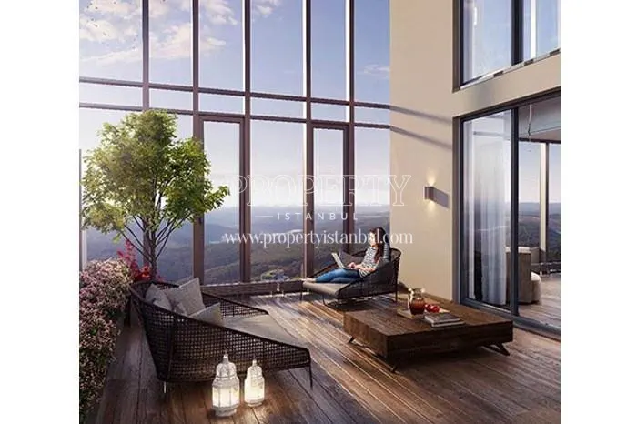 The woman on the balcony which is facing the forest in Sky Residence