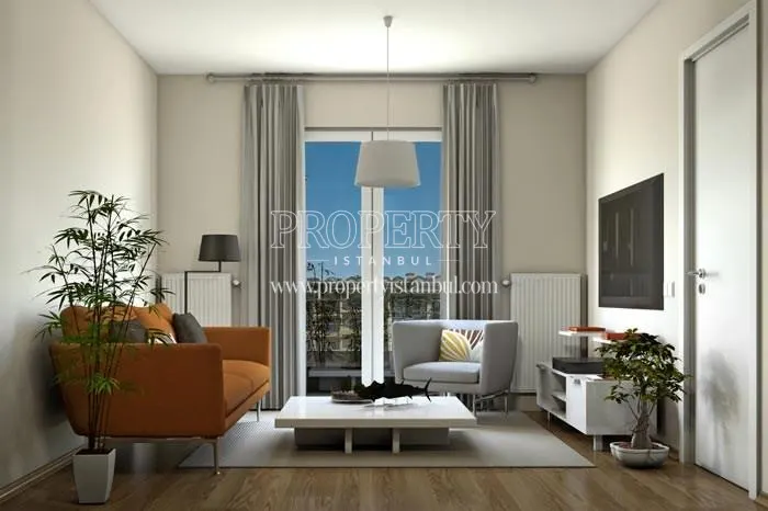 Small living room with an orange sofa in Soyak Konforia