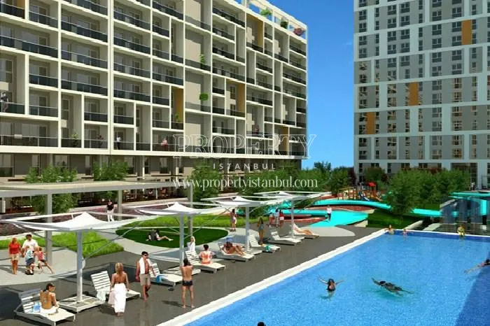 The residents of Soyak Park Aparts swimming and sunbathing in the compound pool