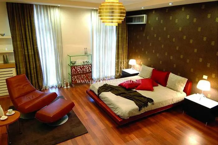 Red bed and armchair in one of the master bedrooms in Starlife Silivri
