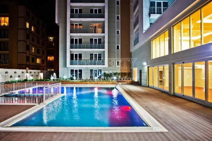 Outdoor swimming pool in Sultan Konutlari at night