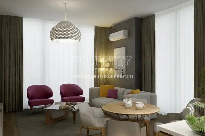The living room with a cream-colored sofa and pink armchairs in Toya Next