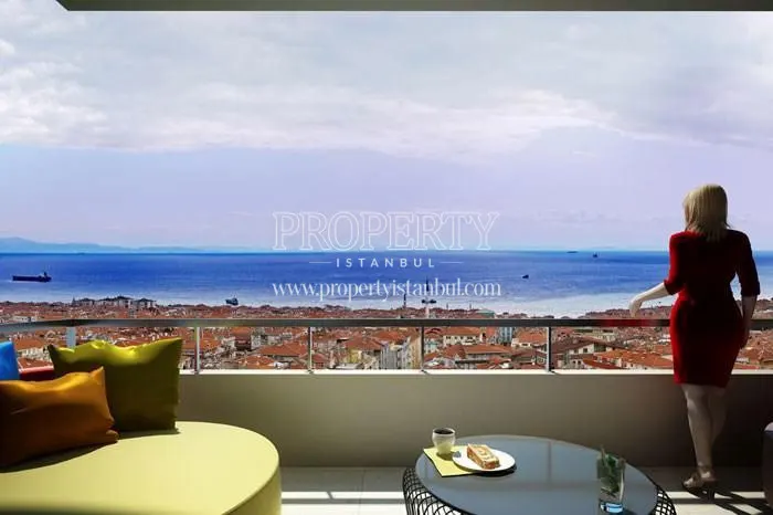 A woman viewing the sea from the balcony in Toya Vista