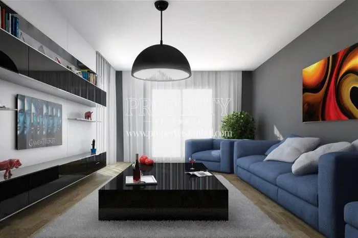 The living room with a blue lounge suite in Tutku Life Residence