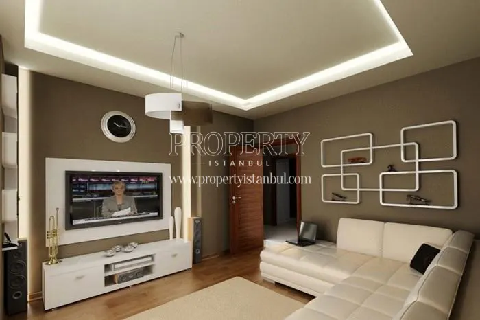 The small living room with a white corner sofa in Tutku Life Residence