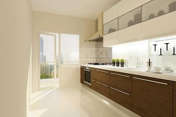 The kitchen having brown wooden and white kitchen cabinets in Venara Bagcilar
